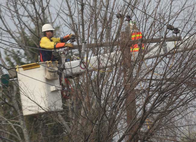 A lineman works to restore power to Massachusetts Avenue.