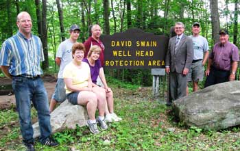 From left: Scott Swain, Kenneth Swain, Nancy-Linn Swain, Dorry Swain, Dave Swain, Rick Dickson, Josh Gould, and Ken Harrod celebrate David Swain’s service to Harvard. (Courtesy photo)