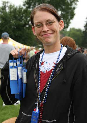 Sarah Maliszewski displays her first place pie-eating ribbons at last year’s Fourth of July celebration. (Photo by Lisa Aciukewicz)