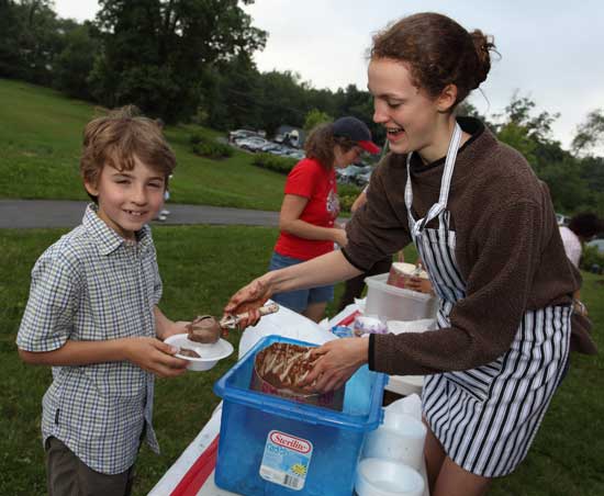 Matthew Carrona gets a scoop of chocolate ice cream from Elizabeth Durham.