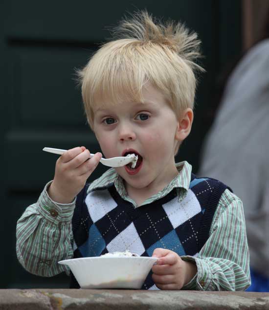 Three-eyar-old Leo Sullivan attacks a bowl of ice cream.