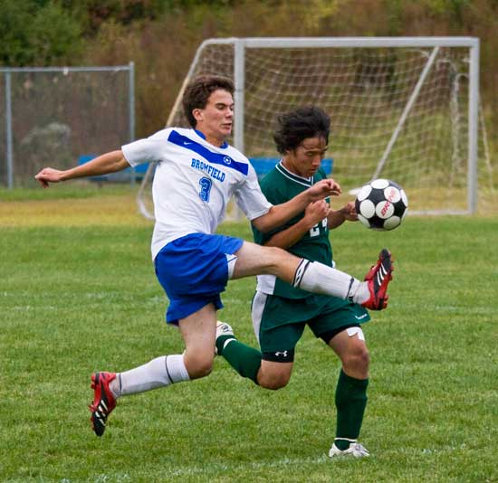 Bromfield senior Greg Deer leaps for the ball against an opponent from Tahanto Regional High School. 