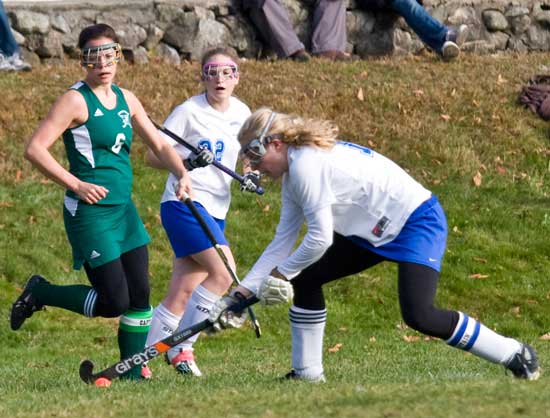 Bromfield senior Sarah Collins maneuvers the ball past her opponent in a Sept. 25 game against Nashoba Regional High School as teammate Ashley Jordan (center) looks on.