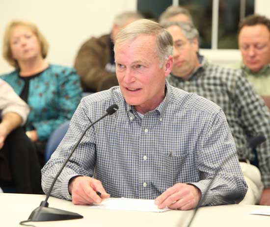 At an all-boards meeting on Jan. 5, Chairman of the Library Trustees, Pete Jackson, discusses the impact of potential library budget cutson accreditation.