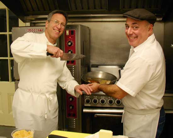 Chefs Paul Correnty (left) and Chris Basile ham it up in the kitchen of Fruitlands Museum while cooking for their cider dinner on Jan. 23. (Photo by Barbara Kemp)