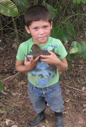  holds a puppy born on the farm where the mission team stayed in 2009.