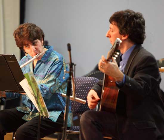 Third-grade teacher Arlene Sullivan (left) and music teacher David Gilfix perform "Quebra Quiexo" by Celso Machado.
