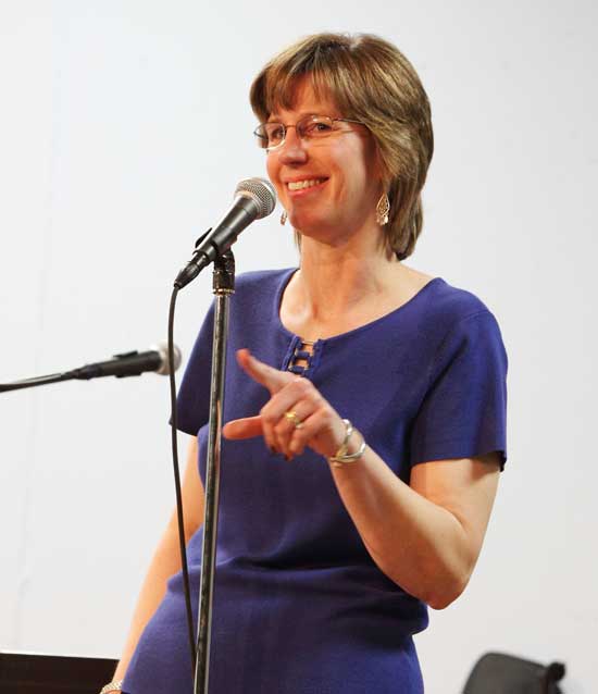 Sharon Schmidt challenges the audience on their memory of the Partridge Family hit, "I Think I Love You."