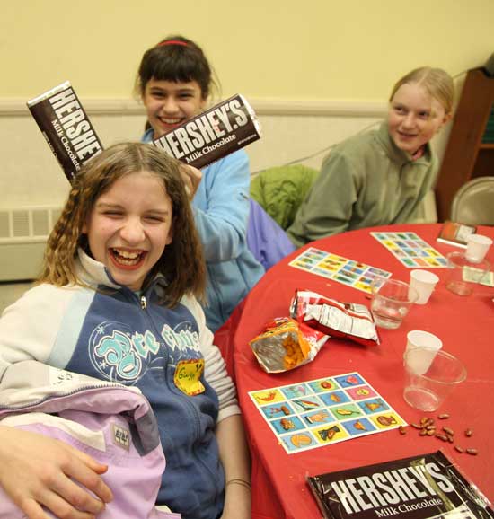 From left: Gwyneth Burns, Suzy Opalka, and Kate Toll play with their chocolate bar winnings at the Girl Scouts’ Mexican Loteria Night at Holy Trinity Parish on Feb. 11.