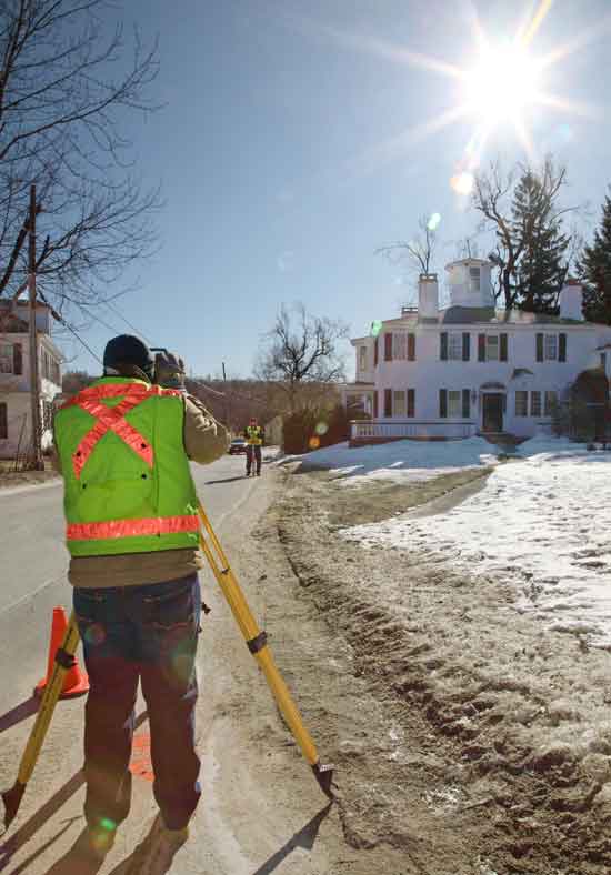 Peter Giakoumis (left) and Peter Jandrisevits of Weston & Sampson Engineering, Inc. take measurements on Feb. 7 while surveying for the town center sewer project