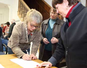 From left: Kirsten Wright signs her nomination papers for a seat on the School Committee as Marty Green and Rhonda Sprague look on at the Town Caucus on March 6. (Photo by Lisa Aciukewicz From left: Kirsten Wright signs her nomination papers for a seat on the School Committee as Marty Green and Rhonda Sprague look on at the Town Caucus on March 6. (Photo by Lisa Aciukewicz