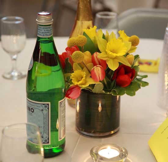 Daffodils, tulips, and craspedia make up the centerpieces provided by Honeyfield Flowers. 