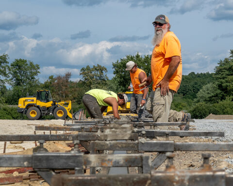 Adam Sloan, senior foreman from Track and Field Installers (TFI), and his crew work on the foundation that will ultimately contain the infield of McCurdy Track. (Photo by Jen Manell)