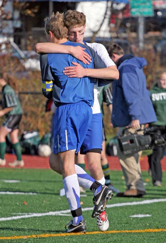 Teammate Josh Lyvers gives goal keeper Toby Frost a hug after their loss in the shootout.