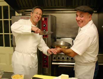 Chefs Paul Correnty and Chris Basile ham it up in the kitchen at Fruitlands while cooking for their cider dinner on Jan. 23. (Photo by Barbara Kemp)