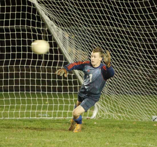 Goalkeeper Ryan Kennedy goes for a block in a sudden-death shootout against Maynard. 